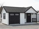 Custom 12x20 Victorian Building with Porch and with White LP Board N Batten Siding, Black Doors, Black Trim, and Black Metal Roof